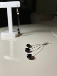 ❤Black Glass Earrings Triple Long Dangling Earrings Water Drop Transparent Earrings Teardrop ❤Handmade Glass earring ❤Black color ❤Consists of 3 small drops of water  ❤Our earrings are handmade and made of 100% natural glass.  ❤Transparent earrings ❤Glass earring with hook ❤Since the products are handmade, there may be slight differences between the pictured and the product you ordered. ❤Handmade Glass jewelry ❤Glass is carefully shaped by melting ❤Each of the small beads: 5 mm ❤Designed in the most suitable dimensions in terms of appearance ❤Due to the cargo density in the world, cargo arrival times may increase by 3-5 days (Please read here) ❤ İf you have any questions or requests feel free to contact me Handmade Black Long Drop Earrings, Black Dangle Linear Earrings For Pierced Ears, Black Hypoallergenic Earrings For Party, Black Teardrop Earrings As Gift, Black Teardrop Earrings With Ear Wire For Gift, Handmade Black Teardrop Earrings For Party, Black Metal Drop Earrings, Modern Black Drop Earrings, Black Dangle Linear Earrings