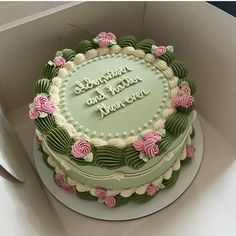 a green and pink birthday cake in a box with the words happy birthday on it