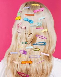 a woman with long blonde hair and lots of clips on her head in the shape of a heart