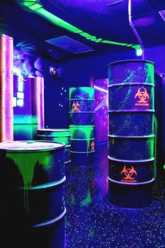 a room filled with barrels covered in neon lights