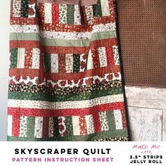 a quilt hanging on a wall next to a piece of wood with the words skyscaper quilt pattern instruction sheet