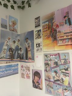 the wall is covered with posters and pictures