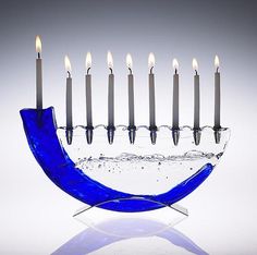 an image of a menorah with candles on it and the words, 500 judaica innovative contemporary ritual art