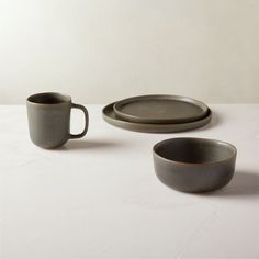 two cups and one plate on a table