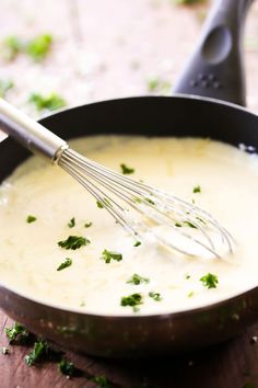 a pan filled with mashed potatoes and garnished with parsley