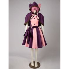 a female mannequin dressed in a dress and hat with pink, purple and black accents