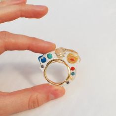 transparent solar system ring big bold statement! i decided to combine two of my favorite motives transparent jelly ring+planets of the solar system it looks like planets floating in space! planets are made of natural stone beads: agate, carnelian, coral, turquoise, lapis lazuli and jade transparent epoxy, gold plated brass i can make it in any size you need, just leave a note with your size while placing an order Solar System Jewelry, Planet Ring, Floating In Space, Handmade Hoop Earrings, Space Jewelry, Botanical Earrings, Transparent Resin, Space Planets, Natural Stone Beads