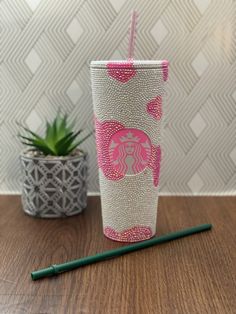 a starbucks cup sitting on top of a wooden table