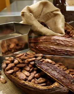 some nuts are sitting on a table next to metal containers and a bag with something in it