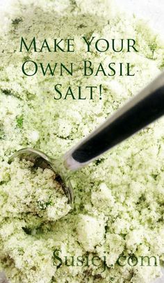 a bowl filled with green stuff next to a spatula and the words make your own basil salt