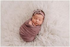 a newborn baby wrapped in a pink wrap