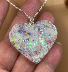 "White Sparkle Heart Necklace, Handmade from Resin and Holographic Flakes. Great Gift for Loved One or Senior Citizen. This is a handmade resin heart by US American veteran, using American manufactured, jewelry quality resin.  White holographic film is cut into small pieces and added to the resin.  White holographic fine glitter is also added to the resin.  This gives the heart an opal look. After the heart shape is created, formed, and allowed to cure for 48-72 hours, it is removed from the mol Jewellery Resin, Resin Hearts, Holographic Film, White Holographic, Epoxy Ideas, Tiny Gifts, Diy Resin Crafts, Resin Projects, Senior Citizen