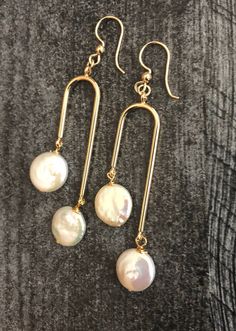 Shop Arch Earrings Gold. Arch earrings will add a perfect touch of flair to your outfit! These modern pearls drop earrings are made from: - 18K Gold plated connectors - White freshwater coin pearls - about 10mm - Gold Filled ear wires- lever back or French hook -please pick from drop-down menu Freshwater pearls are slightly different in size, so it makes every pair unique. Modern statement earrings are 2 7/8 inches long and light. Bohemian Jewelry will make a great gift! Your order will be maile Single Dangle Brass Pearl Earring, White Pearl Drop Earrings In Brass, Dangle Pearl Drop Earrings As Gift, Pearl Drop Dangle Plug Earrings As Gift, Pierced Dangle Pearl Earrings, Brass Dangle Pearl Earrings For Pierced Ears, Dangle Brass Pearl Earrings, Dangle Pearl Earrings With Brass, Adjustable Pearl Drop Earrings For Jewelry Making