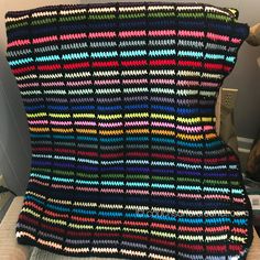 a crocheted blanket sitting on top of a chair