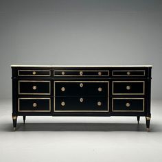 an antique black and gold dresser with brass knobs on the drawers, sideboard or buffet table