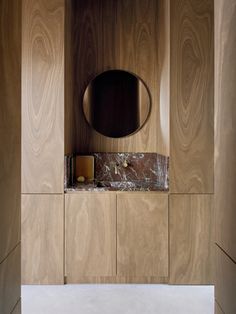 an office with wood paneling and a round mirror on the wall next to it