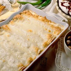 a casserole dish is sitting on a table with other desserts and condiments