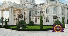 a large white building with columns and arches on the front, surrounded by greenery