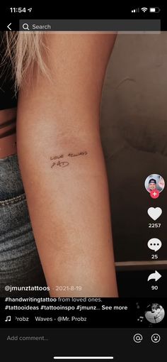 a woman's arm with the word love written on it and an arrow tattoo