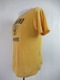 "Vintage 1960s yellow cotton t shirt with black graphics: Richmond Brewers Little League Baseball. Made by Southern Athletic. Size small. Actual measurements are: 38\" around the chest 38\" around the waist 17.5\" shoulder seam to shoulder seam 23\" overall length In \"wrecked\" condition with several holes." Vintage Fitted T-shirt With Letter Print, Retro Yellow Short Sleeve T-shirt, Yellow Retro Short Sleeve T-shirt, Retro Yellow T-shirt With Letter Print, Fitted Yellow T-shirt With Screen Print, Vintage Cotton T-shirt With Screen Print, Vintage Cotton T-shirt With Vintage Print, Yellow Retro Crew Neck Tops, Retro Yellow T-shirt With Graphic Print