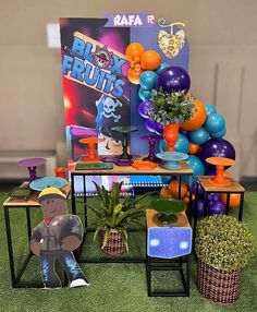 an assortment of colorful balloons and decorations on display in a room with artificial grass flooring