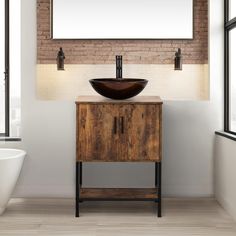 a bathroom with a sink, mirror and brick wall in the back drop off area