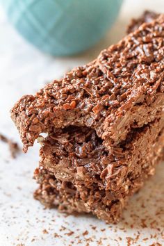 two pieces of chocolate brownie sitting on top of a table