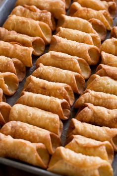 some kind of food that is on a baking sheet and ready to be cooked in the oven