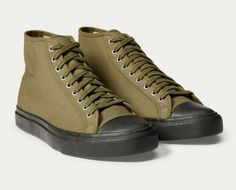 AUTHENTICITY GUARANTEED Style: RRL Sneaker Color: Olive Description: Inspired by a '30s military physical-training sneaker. Made from cotton canvas with a vulcanized rubber outsole. Constructed on a custom Double RL last. Fits true to size. Rounded toe. Lace-up front. Rubber toe cap. Padded canvas insole. Vulcanized rubber outsole. Rubber "RRL" tag at the heel. Cotton. Imported. Available in men's sizes from 5 to 13. We suggest women order two sizes smaller than their usual size. Please see the Outdoor Textile Canvas Shoes With Vulcanized Sole, Khaki Canvas Sneakers With Rubber Sole, Outdoor Cotton Sneakers With Round Toe, Casual Khaki Canvas Sneakers, Cotton High-top Sneakers With Round Toe For Outdoor, Urban Canvas Shoes With Rubber Sole, Canvas Shoes With Gum Sole For Sports, Khaki Sneakers With Vulcanized Sole For Streetwear, Canvas Shoes With Rubber Toe Cap For Sports