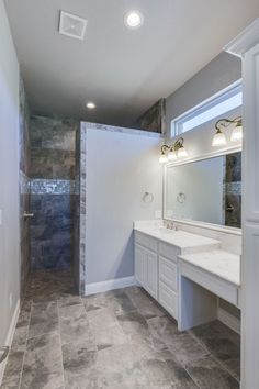 a large bathroom with two sinks and a walk in shower