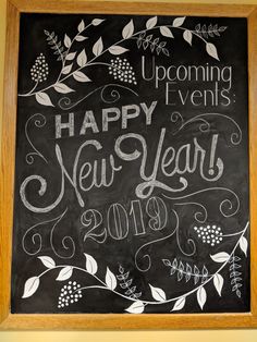 a chalkboard with the words happy new year written on it