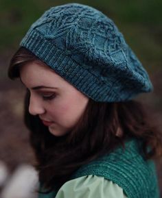 This slouch-style hat begins at the band with a twisted stitch ribbing and is knit in the round. The body of the hat is worked in intertwined “tree bark” twisted stitch patterns, and the crown is shaped with decreases interspersed with small lace leaf motifs. The hat can be knit from a single skein of sock-weight yarn. Choose a semi-solid or tonal colorway to let all the stitch patterning show best. Inspiration: From Greek mythology, dryads were tree nymphs or female tree spirits. Normally consi Lace Leaf, Hat Knitting Pattern, Cable Knitting, Hat Knitting, Knitted Wit, Knit Hats, Knit In The Round, Hat Knitting Patterns, Knitting Accessories