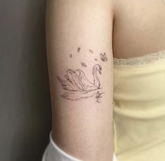 a woman's arm with a tattoo of a swan on the left side of her body