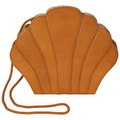 Renaud Pelligrino's elegant caramel "Clam" shaped clutch in textured leather with top stitched accents and rope shoulder strap. 1980's France. Lined in faille. 8" x 9.5" x 1.5". Excellent condition. Ex: Collection of NY Philanthropist Carroll Petrie. Structured Shoulder, Shoulder Bag Brown, Brown Leather Handbags, Handbags Leather, Brown Brown, Genuine Leather Handbag, Leather Purse, Fashion Handbags, Yorkie