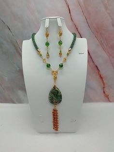 "Handmade and designed by me-one of a kind necklace set-green rainbow seed bead crocheted rope necklace-19\"-5\" long focal with a Mexican crazy lace agate pendant bead and a 3\" seed bead beaded tassel-green and tan glass beads-rose connectors-2 3/4\" long matching dangle earrings-gold tone findings-lobster clasp-1\" extender chain. Add this beautiful necklace set to your jewelry collection-would be an eye catching set for a summer night!" Crochet Gemstone, Green Necklaces, Collar Verde, Collar Rosa, Green Rainbow, Jewerly Beads, Bead Crochet Rope, Crochet Rope, Beaded Jewelry Tutorials