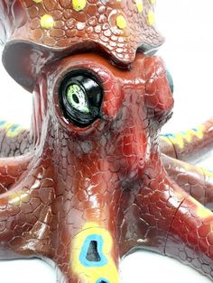 an octopus toy with its eyes open and it's head turned to the side