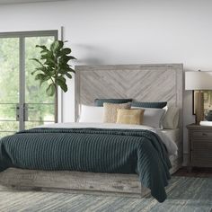 a bedroom with a bed, nightstands and mirror in it's center area