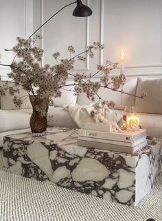 a marble coffee table with flowers in it