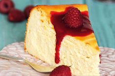 a piece of cheese cake with raspberries on top