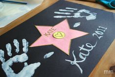 a child's hand and foot prints on a chalkboard