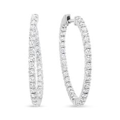 Strike a pose in these gorgeous inside-outside hoop earrings that radiate the luminosity of sparkling prong-set round diamonds. The curved silhouette and the inside-outside design of these hoops ensures maximum diamond exposure. These diamonds shimmer and shine with a total 3 5/8 cttw and an approximate F-G color and VS1-VS2 clarity. Crafted in genuine 18k white gold, these hoop earrings will make the perfect accent to any outfit. These earrings measure 35mm in diameter and secure with push backs. Shimmer And Shine, Summer Clearance, Shimmer N Shine, Stylish Watches, Inside Outside, Strike A Pose, Diamond Gemstone, Gold Material, Round Diamond