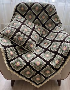 a crocheted blanket sitting on top of a chair