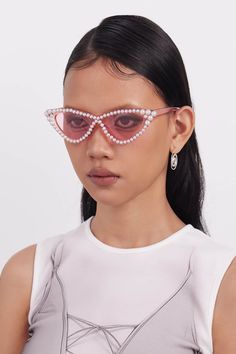 Embrace the perfect fusion of elegance and playfulness with our OPTICALS Pearl-Embellished Cat-Eye Sunglasses. These stunning sunglasses feature inverted triangle-shaped lenses in a classic cat-eye frame, exuding both sophistication and charm. The edges of the frame are adorned with delicate pearls, adding a touch of luxury and refinement. Both the lenses and the frame, including the temples, are semi-transparent, enhancing the chic and modern design. Crafted from premium materials, these sungla Modern Cat Eye Sunglasses For Spring Party, Pink Cat Eye Sunglasses With Gradient Lenses For Party, Chic Cat Eye Sunglasses With Uv Protection For Party, Polarized Cat Eye Sunglasses For Party, Polarized Cat Eye Sunglasses For Parties, Party Cat Eye Sunglasses With Gradient Lenses, Spring Evening Cat Eye Sunglasses, Summer Evening Cat Eye Sunglasses, Elegant Cat Eye Sunglasses With Uva Protection For Party