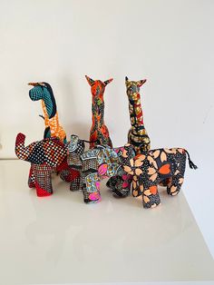 several colorfully painted animal sculptures on a white surface