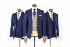 three suits on mannequins in front of white background