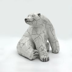 a white ceramic bear sitting on its hind legs