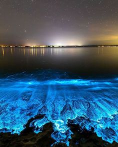 the water is very blue and it looks like something from another planet in the sky