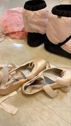 several pairs of ballet shoes sitting on the floor