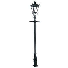 a black lamp post with a cross on it's top and an iron base