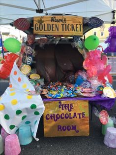 an ice cream stand with balloons and candy